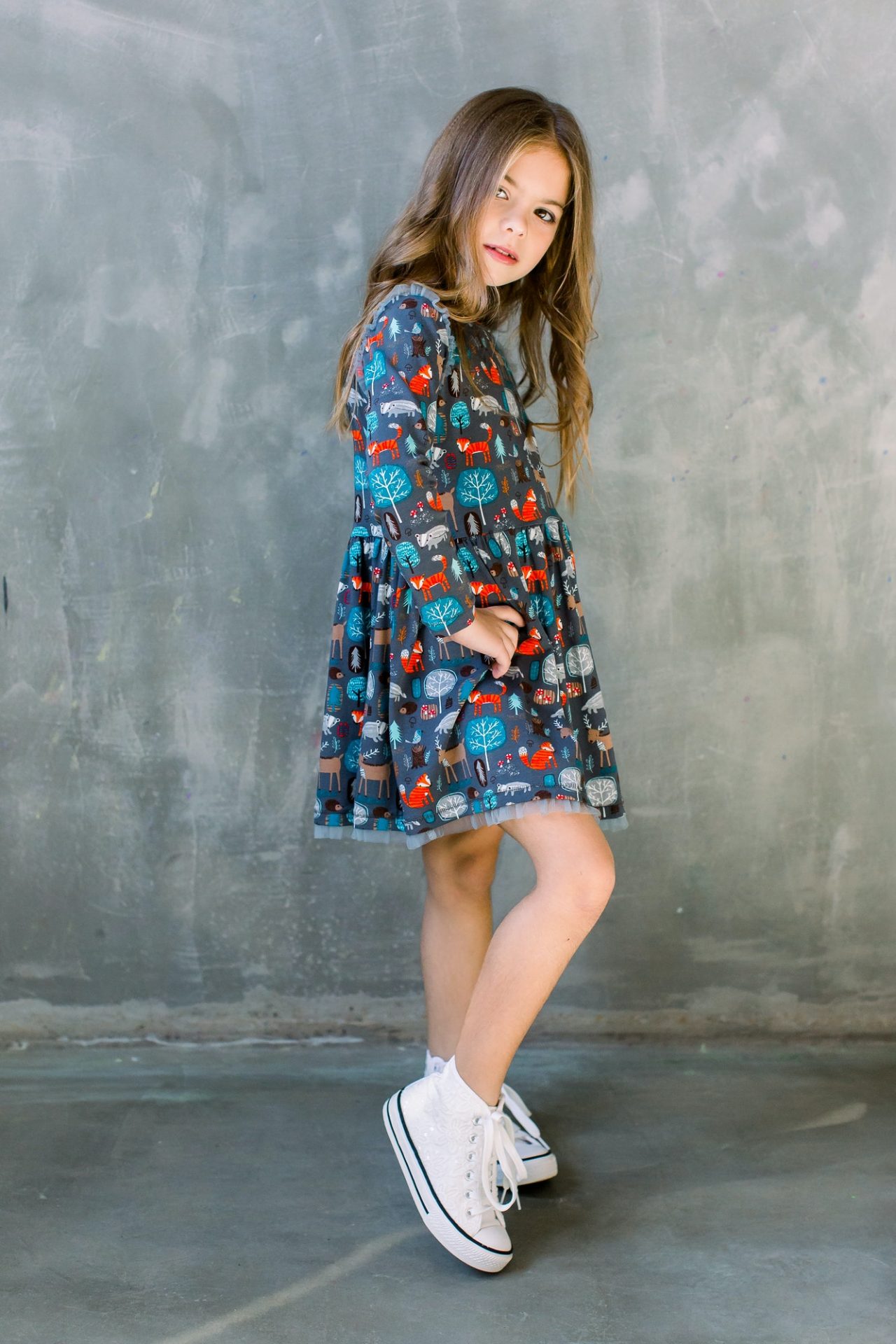 Fashion little girl child in blue dress on a grey background.jpg